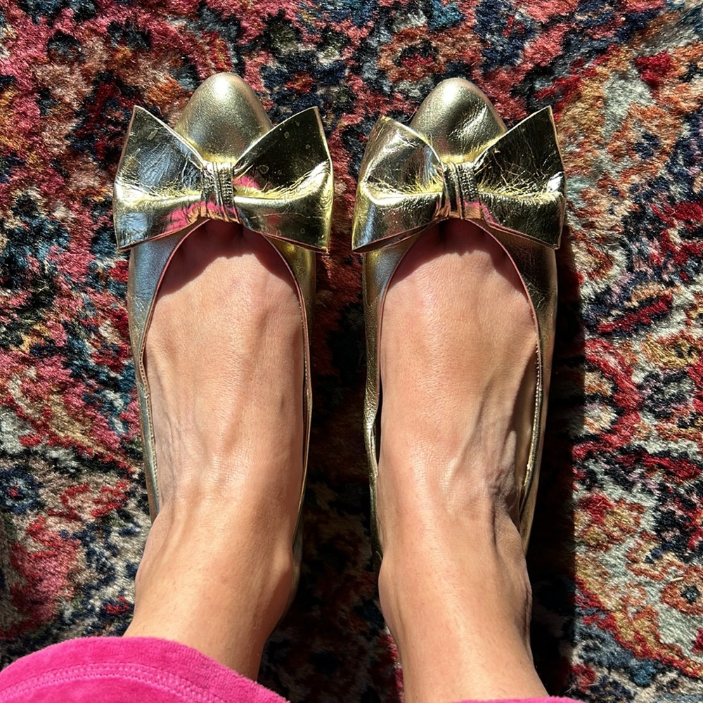 Andrea Carrano gold bow flats
